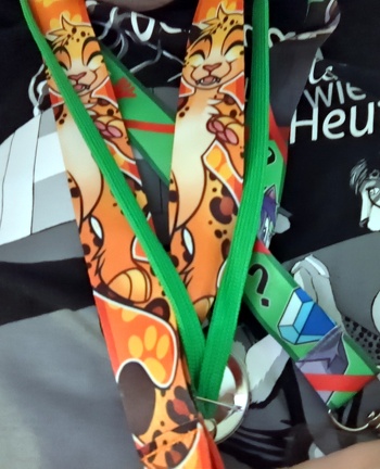 A badge lanyard being worn, showing a happy leopard